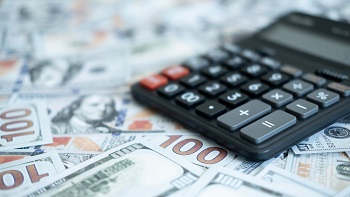 photo of calculator on top of cash